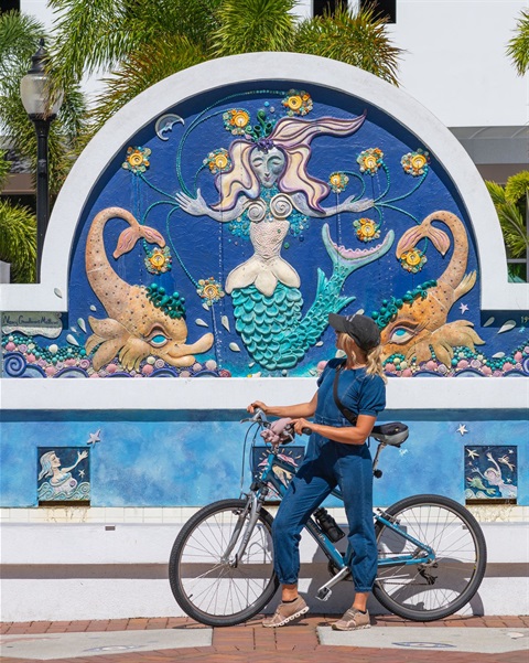A bicyclist stops to admire the Mermaid Fountain